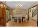 Charming dining room featuring hardwood floors, wooden table with seating for six, and decorative wall art at 6160 Virgilina Rd, Roxboro, NC 27574
