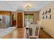 Traditional dining room with wood floors, white chairs, and natural light, adjacent to the kitchen at 6160 Virgilina Rd, Roxboro, NC 27574