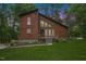 Charming two-story home featuring a brown exterior, stone foundation, and well-manicured front lawn at 6160 Virgilina Rd, Roxboro, NC 27574
