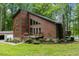 Charming brown exterior home with stone chimney, a front porch, and a detached two-car garage at 6160 Virgilina Rd, Roxboro, NC 27574