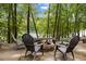 Outdoor fire pit and chairs sit on the patio with lake views, perfect for relaxation at 6160 Virgilina Rd, Roxboro, NC 27574