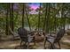 Outdoor fire pit and chairs sit on the patio with lake views, perfect for relaxation at 6160 Virgilina Rd, Roxboro, NC 27574