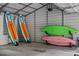 Garage featuring two kayaks and two paddle boards, ready for lake adventures at 6160 Virgilina Rd, Roxboro, NC 27574