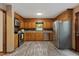 Updated kitchen featuring stainless steel appliances, wooden cabinets, and modern flooring at 6160 Virgilina Rd, Roxboro, NC 27574
