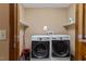 Bright laundry room complete with a washer, dryer, and convenient shelving at 6160 Virgilina Rd, Roxboro, NC 27574