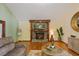 Relaxing living room featuring a stone fireplace, hardwood floors, and views of the surrounding landscape at 6160 Virgilina Rd, Roxboro, NC 27574