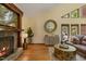 Inviting living room featuring hardwood floors, a stone fireplace, and plenty of natural light at 6160 Virgilina Rd, Roxboro, NC 27574