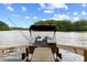 Pontoon boat at the end of a dock with great views of the lake at 6160 Virgilina Rd, Roxboro, NC 27574