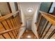 Staircase with wooden steps and black metal railings leading to a lower level at 6160 Virgilina Rd, Roxboro, NC 27574