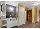 Convenient wet bar featuring tile backsplash, storage cabinets, and sink at 6160 Virgilina Rd, Roxboro, NC 27574