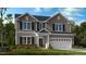 Charming two-story home with gray siding, black shutters, white trim, and a manicured front lawn at 622 Contento Ct, Sanford, NC 27330