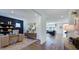Inviting living room with wood floors, and an adjacent office space showcasing a built-in bookshelf and desk at 622 Contento Ct, Sanford, NC 27330