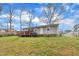 Large backyard featuring a well-kept lawn, a deck, and mature trees, perfect for outdoor activities at 715 Shay Dr, Durham, NC 27704