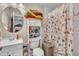 Cozy bathroom with a toilet, vanity, and shower, plus storage on a shelf above the commode at 715 Shay Dr, Durham, NC 27704