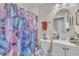 Well-maintained bathroom featuring a vanity, toilet, and shower with a vibrant butterfly-themed curtain at 715 Shay Dr, Durham, NC 27704
