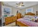 Bedroom featuring wooden furniture, a ceiling fan, and natural light, perfect for a relaxing retreat at 715 Shay Dr, Durham, NC 27704