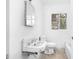 Bathroom featuring an old sink, toilet, window, and white walls at 740 Long Ave, Rocky Mount, NC 27801