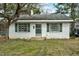 Charming one-story home with white brick, green shutters, and mature trees at 740 Long Ave, Rocky Mount, NC 27801