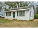 Charming one-story home with white brick, green shutters, and mature trees at 740 Long Ave, Rocky Mount, NC 27801