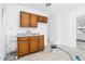 Compact kitchen with wooden cabinets, a sink, and white walls at 740 Long Ave, Rocky Mount, NC 27801