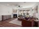 Cozy living room featuring a fireplace, plush seating, and abundant natural light from large windows at 744 Ben Ledi Ct, Raleigh, NC 27603