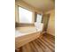 Bright bathroom featuring a separate shower and tub and wood look floors at 78 Florence Dr, Clayton, NC 27527