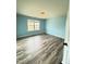 Bright bedroom with blue walls, gray flooring, and natural light at 78 Florence Dr, Clayton, NC 27527