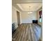 Dining room featuring tray ceilings, wood-look floors, and picture frame wainscoting at 78 Florence Dr, Clayton, NC 27527