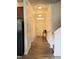 Hallway featuring wood-look floors, wainscoting, light-colored walls and white trim at 78 Florence Dr, Clayton, NC 27527