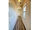 Light and bright hallway with wood look floors and a walk in closet at 78 Florence Dr, Clayton, NC 27527