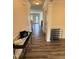 Hallway featuring wood-look floors, wainscoting, light-colored walls and white trim at 78 Florence Dr, Clayton, NC 27527