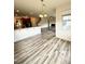 Open-concept living room featuring modern gray flooring that connects the living, dining, and kitchen areas at 78 Florence Dr, Clayton, NC 27527