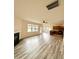 Open-concept living room and kitchen featuring wood floors and a fireplace at 78 Florence Dr, Clayton, NC 27527