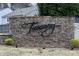 Community sign on a stone wall with landscaping at 78 Florence Dr, Clayton, NC 27527