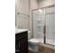 Bathroom with glass shower enclosure, built-in shelves, and a dark vanity with white countertops at 802 Hillfarm Dr, Wake Forest, NC 27587