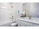 Well-lit bathroom with a tub, shower, modern vanity, and quartz countertop, providing a functional and stylish design at 802 Hillfarm Dr, Wake Forest, NC 27587