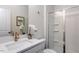Clean bathroom with white cabinetry, quartz countertop, and glass-enclosed shower, offering a fresh and modern design at 802 Hillfarm Dr, Wake Forest, NC 27587