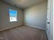 Cozy bedroom with neutral carpet, a bright window, and ample closet space at 802 Hillfarm Dr, Wake Forest, NC 27587