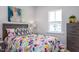 Comfortable bedroom with colorful bedding and plenty of natural light, creating a cozy and cheerful space at 802 Hillfarm Dr, Wake Forest, NC 27587
