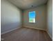Comfortable bedroom featuring neutral carpeting and a window offering natural light at 802 Hillfarm Dr, Wake Forest, NC 27587
