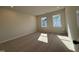 Well-lit bedroom showcasing neutral walls and carpet, brightened by natural light from dual windows at 802 Hillfarm Dr, Wake Forest, NC 27587