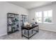Well-organized home office with a sleek desk, shelves, and natural light, perfect for productivity and focus at 802 Hillfarm Dr, Wake Forest, NC 27587
