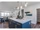 Kitchen island with quartz countertop, modern gray cabinets, and views into the living and dining spaces at 802 Hillfarm Dr, Wake Forest, NC 27587