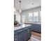 Bright kitchen with gray cabinets, white quartz countertops, gold hardware, and stainless steel appliances at 802 Hillfarm Dr, Wake Forest, NC 27587