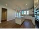 Modern kitchen boasts an island with quartz countertops and pendant lighting, plus stainless appliances at 802 Hillfarm Dr, Wake Forest, NC 27587
