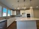 Beautiful kitchen with a large center island, stainless steel appliances, and modern lighting fixtures at 802 Hillfarm Dr, Wake Forest, NC 27587