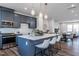 Open-concept kitchen with large island, pendant lighting, stainless steel appliances, and gray cabinetry at 802 Hillfarm Dr, Wake Forest, NC 27587