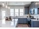 Modern kitchen featuring gray cabinets, stainless steel appliances, and a quartz countertop island at 802 Hillfarm Dr, Wake Forest, NC 27587