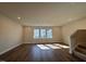 Bright living room with hardwood floors, recessed lighting, and large windows allowing for abundant natural light at 802 Hillfarm Dr, Wake Forest, NC 27587