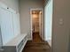 Mudroom has a bench with coat hooks and shelves for shoe storage, leading to a bathroom at 802 Hillfarm Dr, Wake Forest, NC 27587